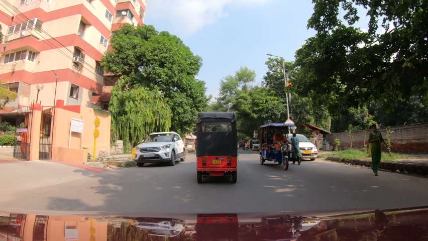 Car pov, heavy traffic in New Delhi, India