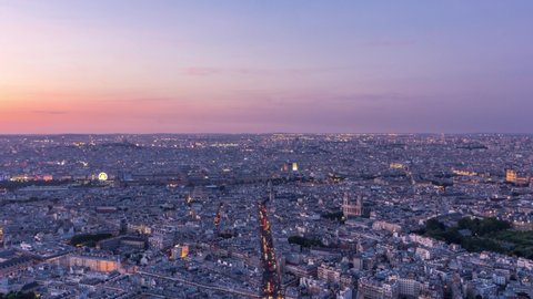 Panorama of Paris after sunset day to night transition timelapse. Top view from observation deck of montparnasse building in Paris - France. Colorful sky at summer day
