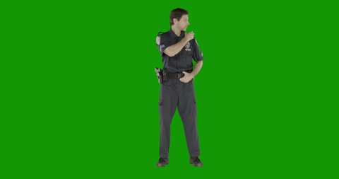 CHROMA KEY Caucasian male police officer standing against green screen. Model and property released for commercial use