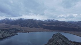 A bird's eye view of a clear mountain volcanic lake, video filmed from a drone. Landscape on the background of mountains and water. virgin nature. Norway
