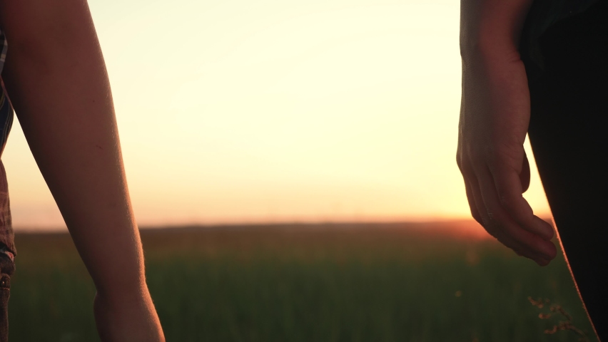 happy family mom and son hold hands close-up teamwork. mother and boy kid together hands at sunset. parent girl and child happy childhood lifestyle. happy family mother day concept Royalty-Free Stock Footage #1062315538