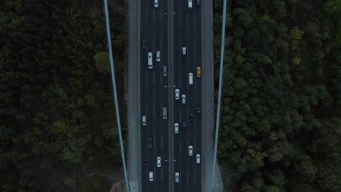 Cars driving onto Bridge towards City Skyline in Istanbul, Turkey over Bosphorus, Aerial birds eye view tilt up