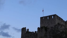 Birds Flying and Fighting For A Place On Top Of The FlagStuff. Flapping Turkish Flag On Top Of The Anatolian Fortress
