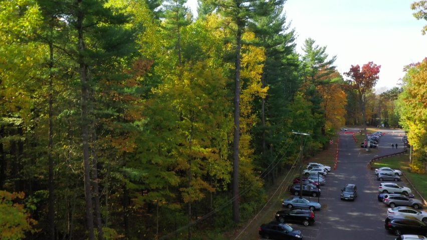 View of Colorful Trees in Autumn near a parking lot