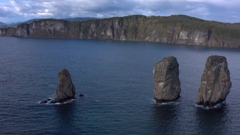 Natural monument and symbol of Petropavlovsk-Kamchatsky. Three Brothers is a group of three pillar-like rocks protruding from the water, located at the entrance to Avachinskaya Bay in Kamchatka.