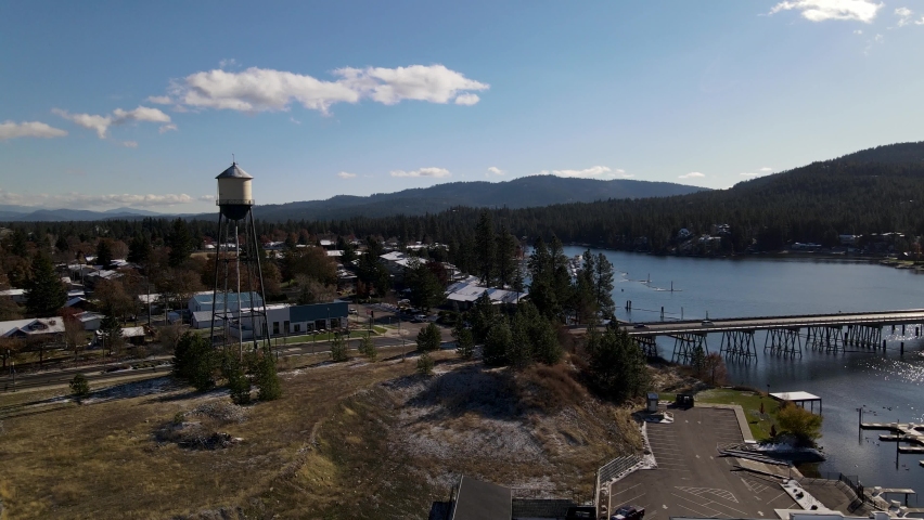 Flying past a water tower and bridge in the small town of Post Falls Idaho along the Spokane River on a sunny fall day.