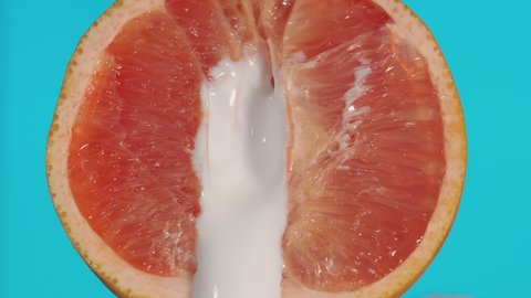 Leaking of white liquid from the half of grapefruit, indicating sexual intercourse, sex. Concept of unprotected sex, sexually transmitted diseases. Unwanted pregnancy