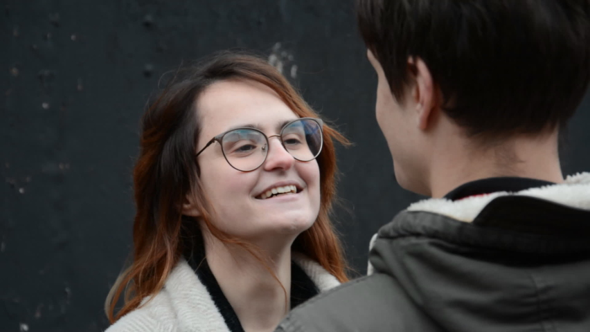 boy and girl portraits stand together and look at each other