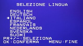 Choosing the language on a VCR VHS player recorder. Menu choices: English, German, Italian, Spanish, French, Dutch, Russian, Sweden. White characters on blue background. Distorted MAIN MENU
