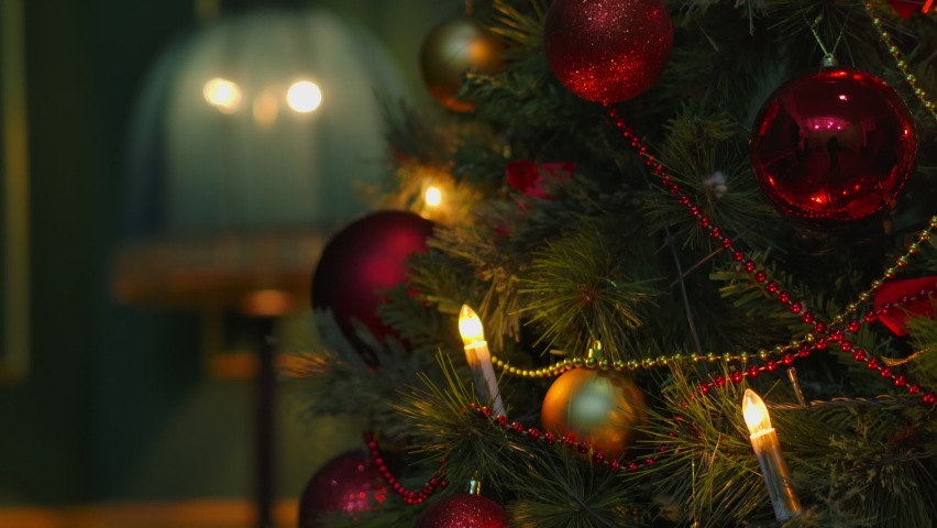 Christmas tree. Hanging Christmas decoration on tree with lights and beautiful balls  Close up. Shot on Cinema Camera | Shutterstock HD Video #1062345085