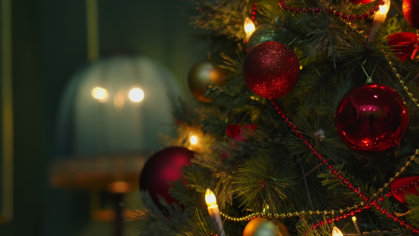 Christmas tree. Hanging Christmas decoration on tree with lights and beautiful balls  Close up. Shot on Cinema Camera | Shutterstock HD Video #1062345085