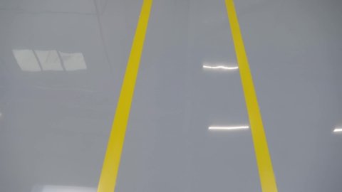 New epoxy floor with colored markings in a car workshop.