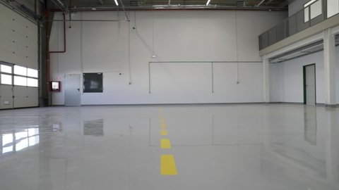 New epoxy floor with colored markings in a car workshop.