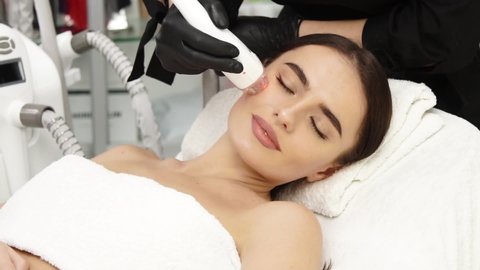 beautiful woman lying at spa and having facial procedures