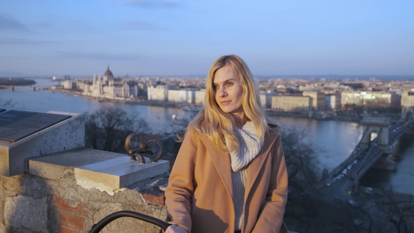 portrait of a woman at sunset on the lookout overlooking budapest