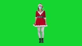 Young woman in Santa Claus costume with facial mask presenting empty space. Full body on chroma key green screen