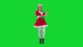 Happy confident Santa Claus girl in Christmas costume presenting and announcing. Full body on chroma key green screen