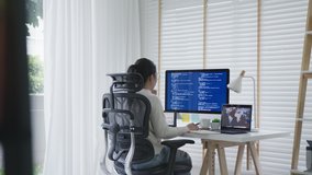 Back rear view of young asian woman, freelance data scientist work remotely at home coding programming on Big data mining, AI data engineering, IT Technician Works on Artificial Intelligence Project. - Powered by Shutterstock - Get 15% off with code: PIKWIZARD15