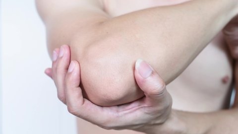 Men use their hands to hold their elbows as He had pain at the elbows. Painful Health and medical concepts