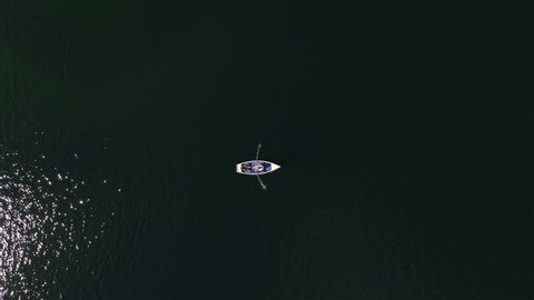 Birds Eye View of rowboat on a lake, couple, shipping, landscape, nature, love, relax, dinghy, static, lovers, aerial drone shot
