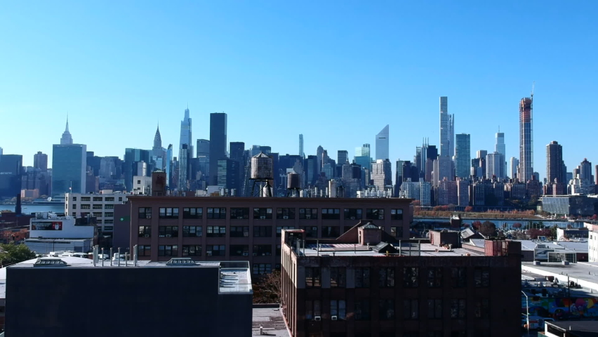 Waterfront High-rise Buildings In Hunter's Point Across East River With Blue Sky In Background In Long Island City, NYC, USA. - aerial Royalty-Free Stock Footage #1062374695