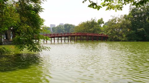The Welcoming Morning Sunlight Bridge leading to the island where the Temple of the Jade Mountain is located on the Hoan Kiem Lake in central Hanoi, Vietnam