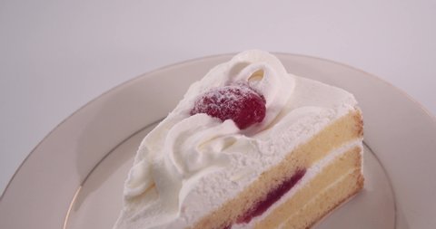 Pan left close-up Japanese Strawberry Shortcake (Layer cake) on plate.