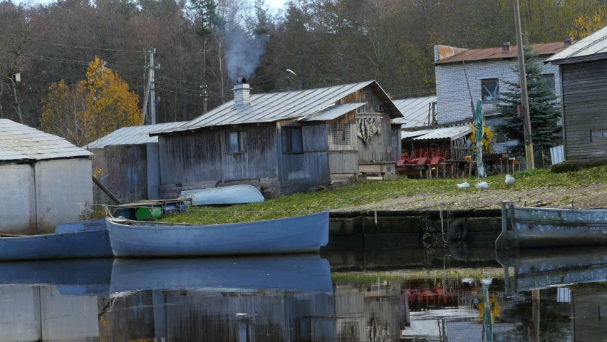 beautiful landscape with boats and farmhouse with smoking chimneys