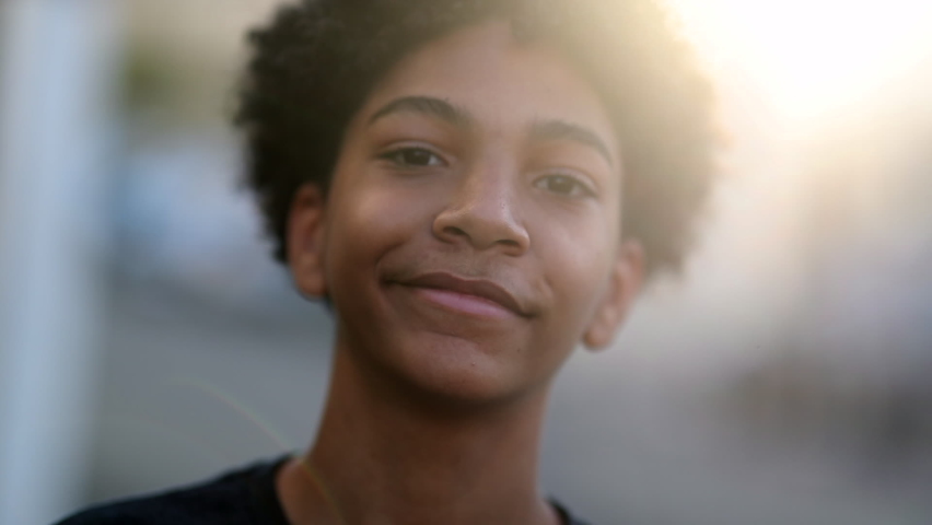 Child boy smiling to camera portrait, mixed race kid, ethnically diverse boy smile in sunlight outdoors. | Shutterstock HD Video #1062393130