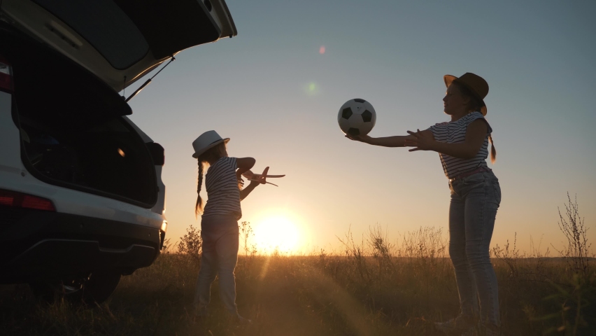 Happy family in park.Children have fun playing ball, pilot of plane.Children dream to travel.Ball game in park at sunset. child pilot of an airplane dreams of flying.Family child is having fun happy. | Shutterstock HD Video #1062393238