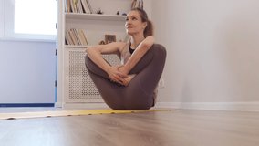 Beautiful young woman doing yoga at home. asanas on yoga mat. Vintage tonned. close up Shot video. Slow motion.