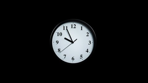 Slowly approaching a wall clock on a black background