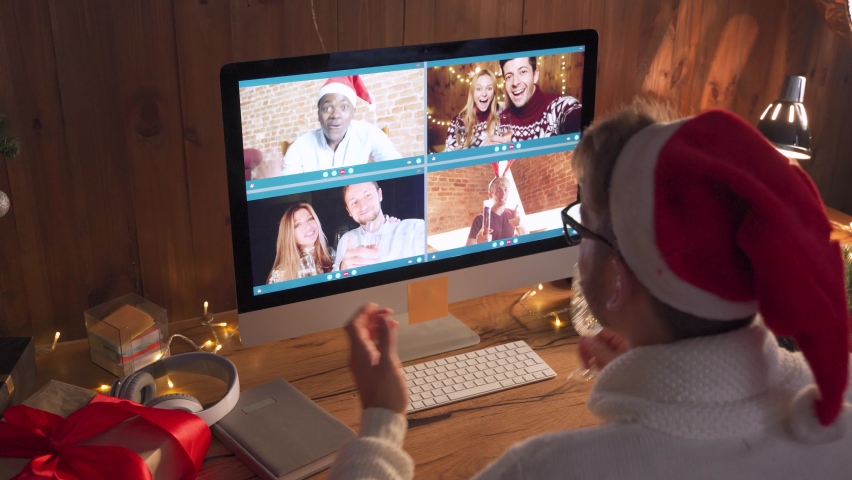 Diverse friends celebrate New Year party on video conference call. Young guy wearing santa hat drinking champagne during virtual Christmas celebration on videocall distance online chat on pc at home. Royalty-Free Stock Footage #1062401173