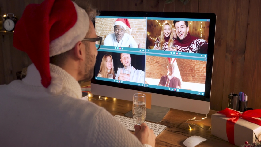 Happy young man wearing santa hat drinking champagne talking to friends on virtual zoom 
video call celebrate New Year party in holiday distance online conference chat together using computer at home. Royalty-Free Stock Footage #1062401233