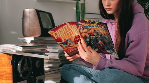 Rostov-on-Don/Russia - 20 October 2020: young woman reading comic book at home.