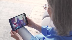 Old senior grandmother holding digital tablet computer video conference calling granddaughter opening Christmas gift in virtual family online chat social distance party meeting, over shoulder view. - Powered by Shutterstock - Get 15% off with code: PIKWIZARD15
