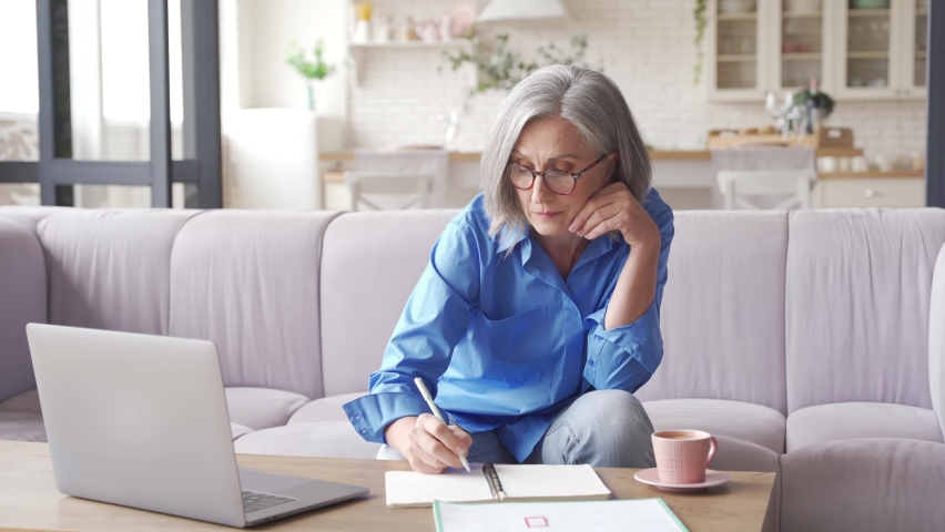 Middle aged older woman watching business training, online webinar on laptop computer remote working or social distance learning from home. 60s businesswoman video conference calling in virtual chat. | Shutterstock HD Video #1062408187