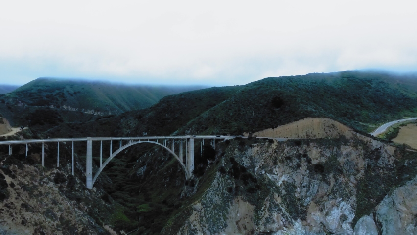 Aerial panorama of Bixby Creek Bridge between the green rocks at Big Sur, California, USA