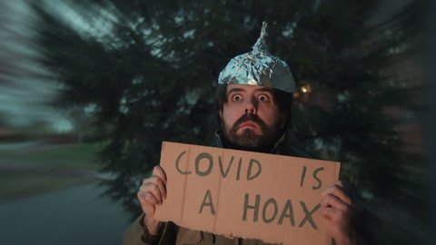 Crazy guy with a tin foil hat claiming covid is a hoax.