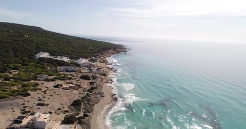 4K slow drone panning shot to reveal hotels on Formentera.