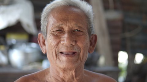 Slow motion scene of white-haired Asian elderly men do not wear clothes because of hot weather, poor status, older than seventy are laughing happily.