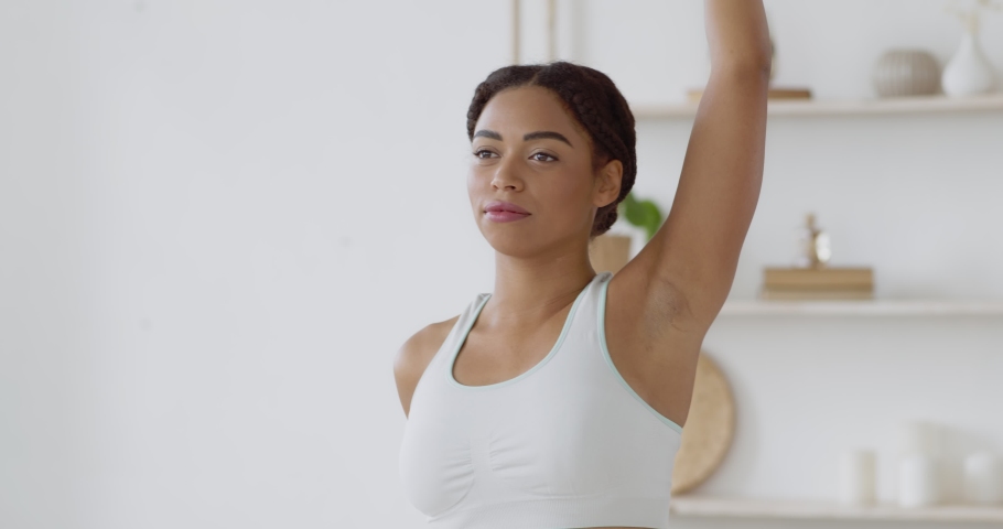 Young sporty african american woman warming up hands, preparing for fitness workout at home, close up, slow motion Royalty-Free Stock Footage #1062422785