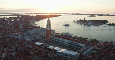 Aerial view of scenic panorama of famous landmark San Marco square with Campanile and Saint Mark's Basilica with nobody during covid-19 lockdown at sunset in Venice, Italy.
