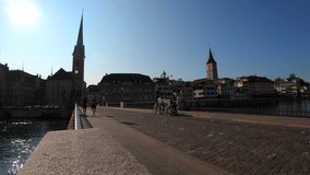 Sunny day in Zurich. Cinematic view of Münsterbrücke, St. Peter's Church. Switzerland. Time-lapse.
