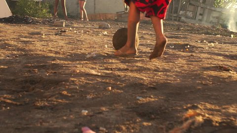 Pov, kids play soccer on a dirt field in a favela, Rio de Janeiro, Brazil