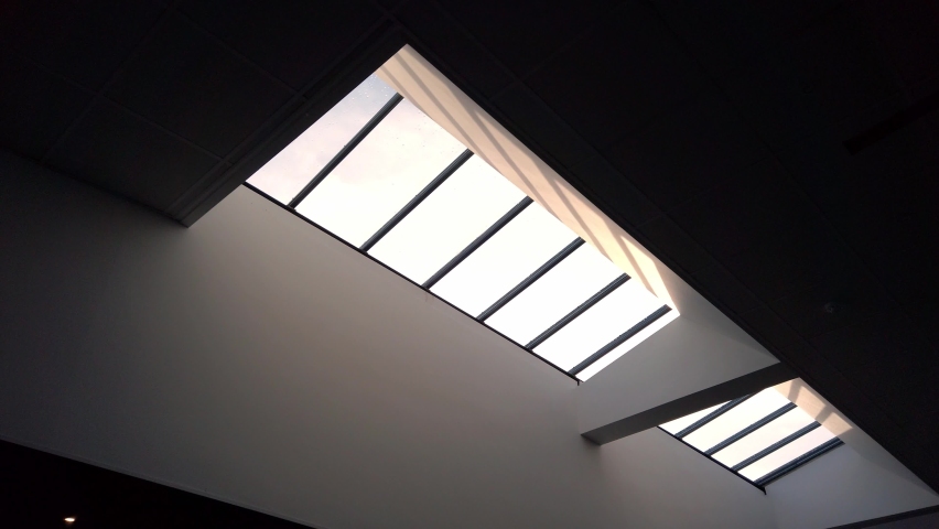 Abstract shot looking up at sky light window in modern building  Royalty-Free Stock Footage #1062446146