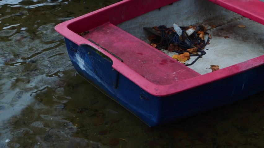 A red boat on the water bank in nature
