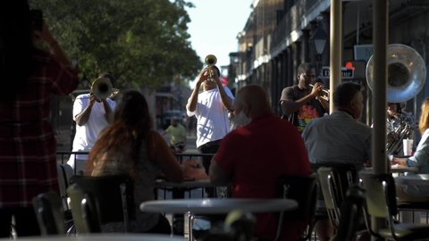  New Orleans, LA/USA - November 4, 2020: Street musicians entertain patrons of Cafe Du Monde, a popular New Orleans tourist spot.