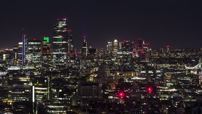 Establishing Aerial View Shot of London UK, St Pauls Cathedral and City of London at night late evening, United Kingdom, city neons