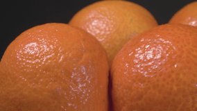 Organic tangerines close up. Exotic fruit on a black background.